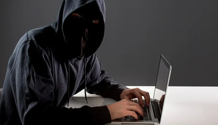side-view-male-hacker-with-laptop_23-2148578154