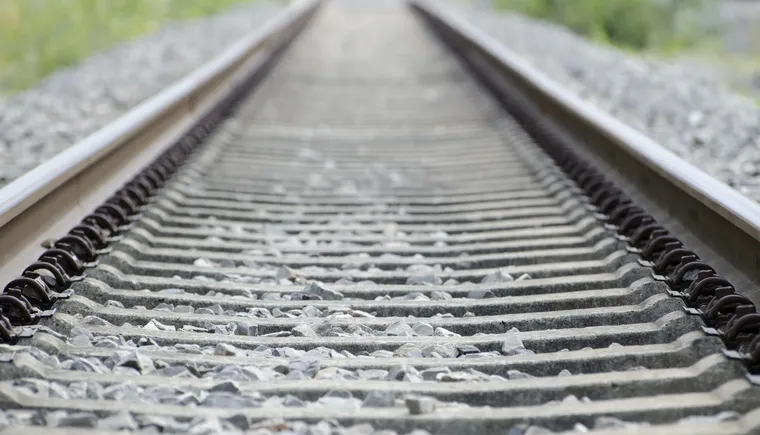 high-angle-shot-old-rusty-railway-tracks-covered-small-stones