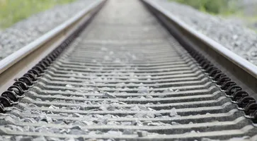 high-angle-shot-old-rusty-railway-tracks-covered-small-stones