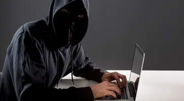 side-view-male-hacker-with-laptop_23-2148578154
