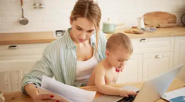 https://ognikubani.ru/wp-content/uploads/2022/12/serious-concentrated-young-female-studying-papers-hands-paying-bills-online-sitting-kitchen-table-front-open-laptop-holding-baby-son-her-lap-little-child-typing-portable-computer_1