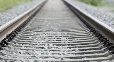 high-angle-shot-old-rusty-railway-tracks-covered-small-stones