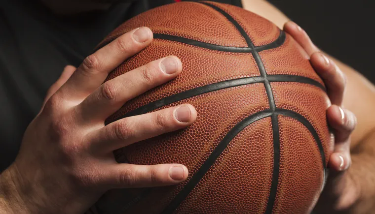 https://ognikubani.ru/wp-content/uploads/2023/01/close-up-of-hand-held-basketball