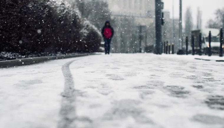 https://ognikubani.ru/wp-content/uploads/2023/02/low-angle-shot-of-a-person-walking-on-the-snow-covered-sidewalk-under-the-snow_1