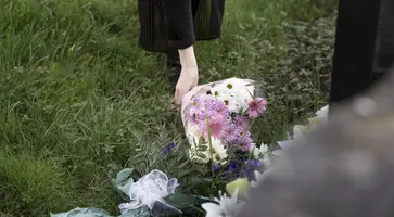 https://ognikubani.ru/wp-content/uploads/2023/03/close-up-flowers-placed-on-the-grave-of-loved-one