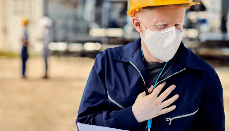 https://ognikubani.ru/wp-content/uploads/2023/03/albino-construction-worker-with-face-mask-holding-his-chest-in-pain-while-working-outdoors