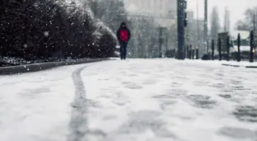 https://ognikubani.ru/wp-content/uploads/2023/02/low-angle-shot-of-a-person-walking-on-the-snow-covered-sidewalk-under-the-snow_1