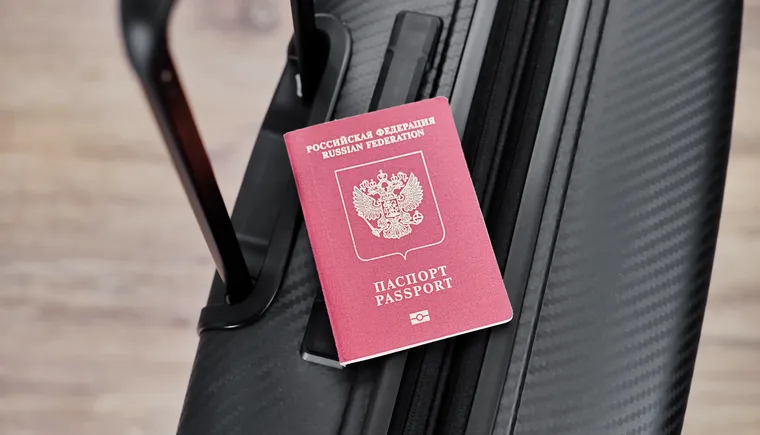 russian-passport-black-travel-suitcase-top-view-selective-background-emigration-russians-seeking-asylum