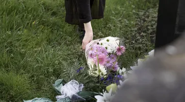 https://ognikubani.ru/wp-content/uploads/2023/03/close-up-flowers-placed-on-the-grave-of-loved-one
