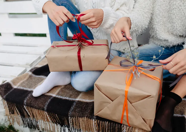 two-beautiful-women-sitting-bench-holding-their-hands-gifts-close-view (1)