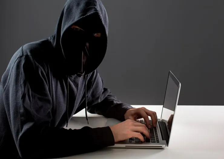 side-view-male-hacker-with-laptop_23-2148578154