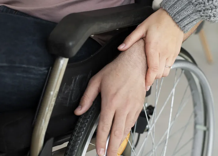 young-adult-helping-disabled-friend
