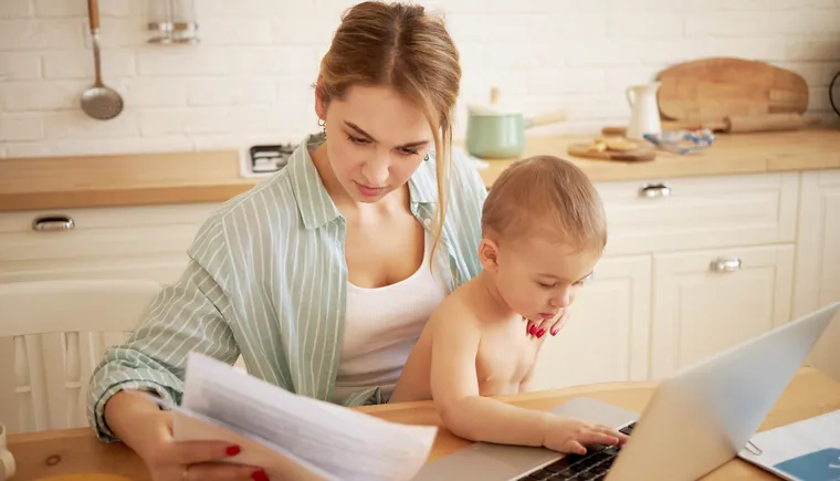 https://ognikubani.ru/wp-content/uploads/2022/12/serious-concentrated-young-female-studying-papers-hands-paying-bills-online-sitting-kitchen-table-front-open-laptop-holding-baby-son-her-lap-little-child-typing-portable-computer_1